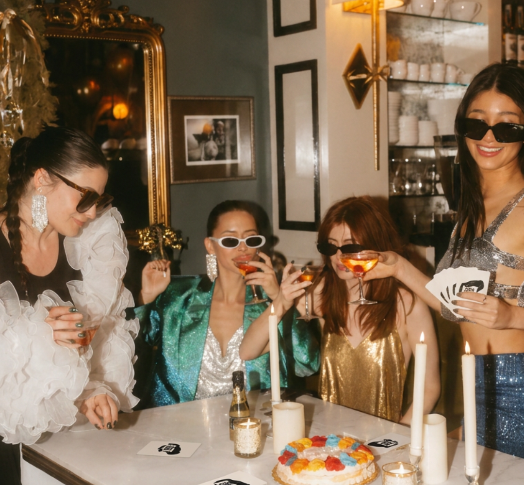 Women playing a party card game at a bachelorette party