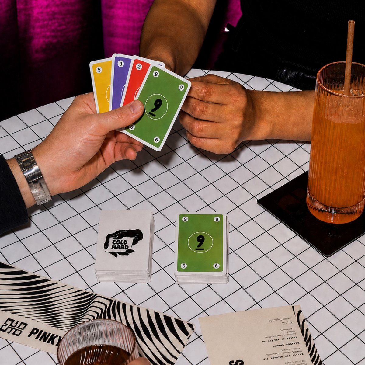 Friends playing Cold Hand party card game at a table